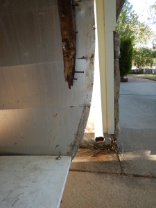 front of trailer on the street side. See how the metal siding is equal to the floor. Well its not the same as the  curb side. Thats not good.